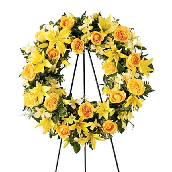 Yellow floral wreath on a black easel stand