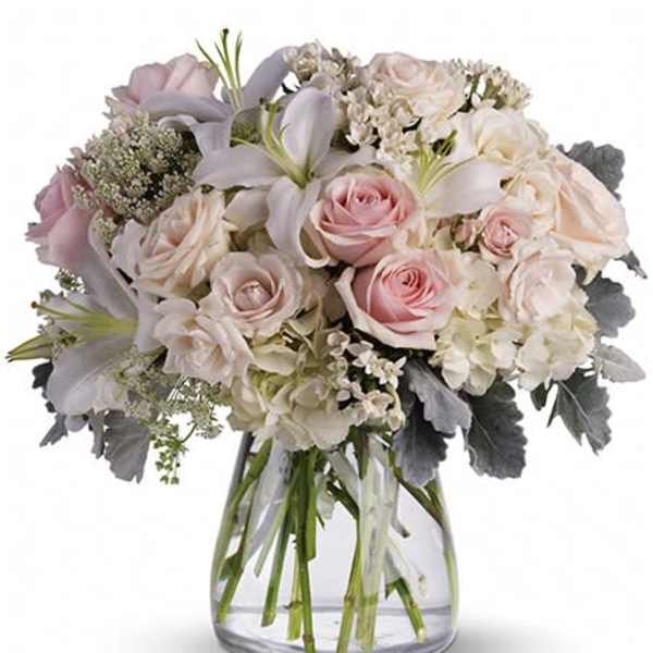 Blush and white rose bouquet in a clear glass vase
