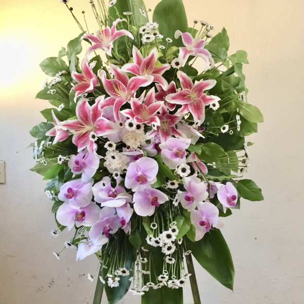 Standing floral spray with pink lilies and pale orchids