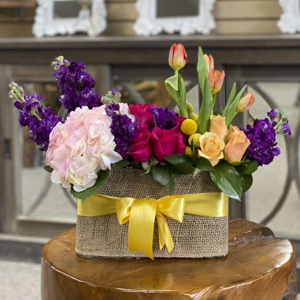 Mixed bouquet in a burlap-wrapped box with a yellow ribbon
