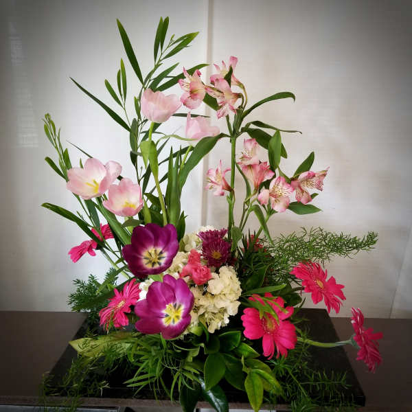 Tall mixed bouquet with pink tulips, alstroemeria, and magenta daisies