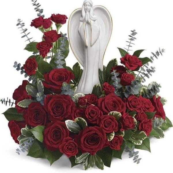Red rose arrangement around a white angel figurine