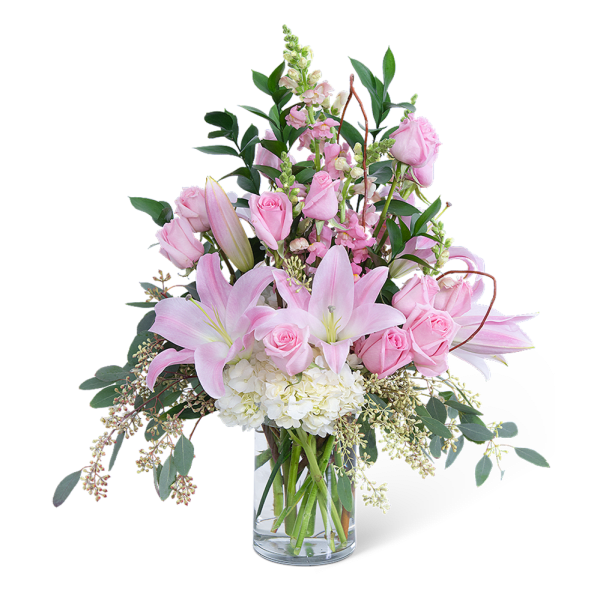 Pink roses and lilies in a clear glass vase