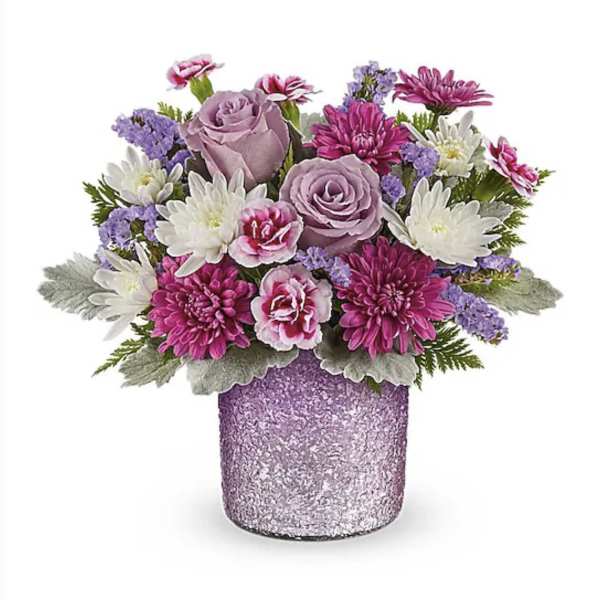 Bouquet of pink and lavender flowers in a glittery purple vase