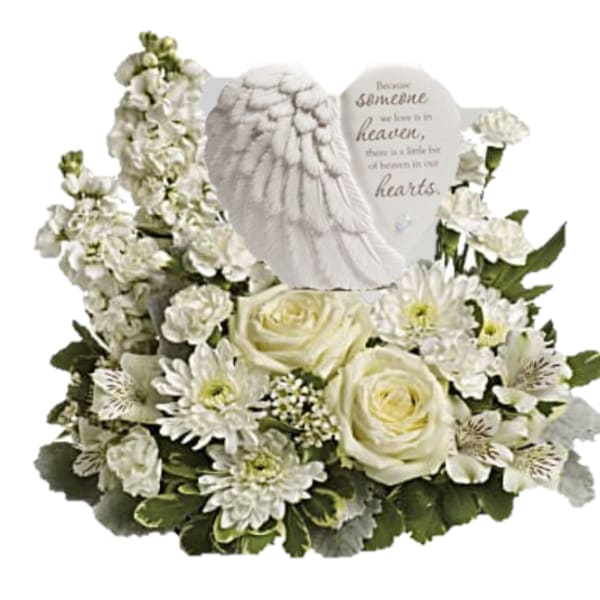 White floral sympathy arrangement with roses and a memorial angel plaque