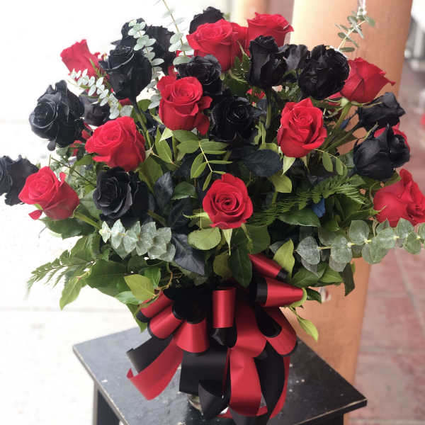 Bouquet of red and black roses with a red-and-black ribbon bow