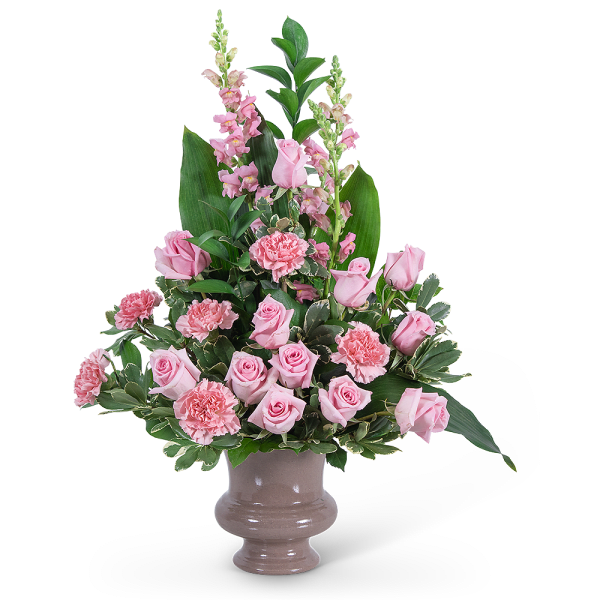 Pink roses and carnations in a ceramic vase