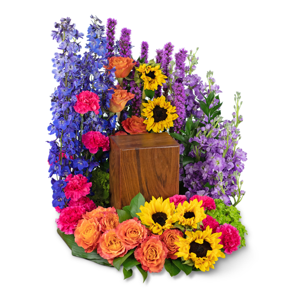 Colorful floral wreath with sunflowers, roses, and purple blooms around a wooden urn