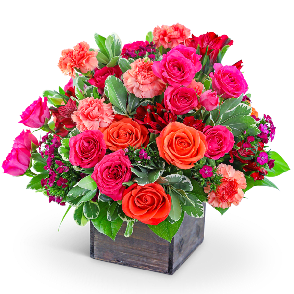 Mixed bouquet of pink and orange roses with carnations in a wooden box
