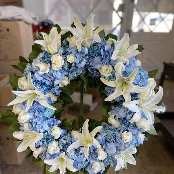 Blue hydrangea wreath with white lilies and small white roses