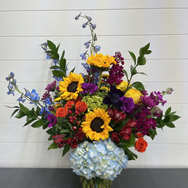 Colorful mixed flower arrangement in a clear glass vase