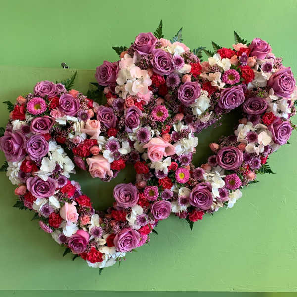 Heart-shaped floral wreath with purple roses and pink-white blooms