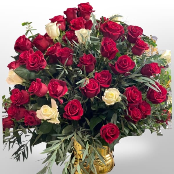 Bouquet of red and white roses in a gold vase