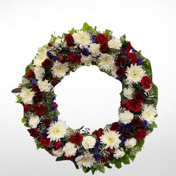 Circular floral wreath with red, white, and blue flowers