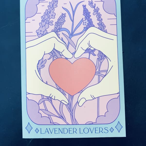 Illustrated hands forming a heart around a pink heart with lavender flowers