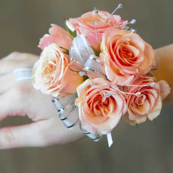 Small bouquet of peach roses with silver ribbon accents