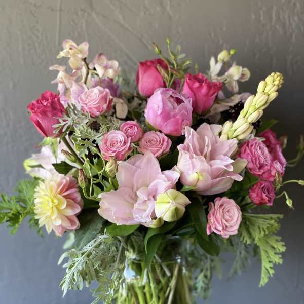 Pink and blush mixed bouquet in a clear glass vase