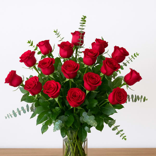 Red roses arranged in a clear glass vase