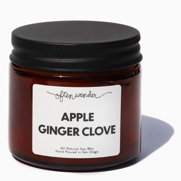 Amber glass jar candle with black lid and Apple Ginger Clove label