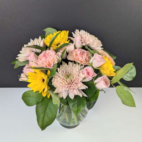 Pink and yellow mixed bouquet in a clear glass vase