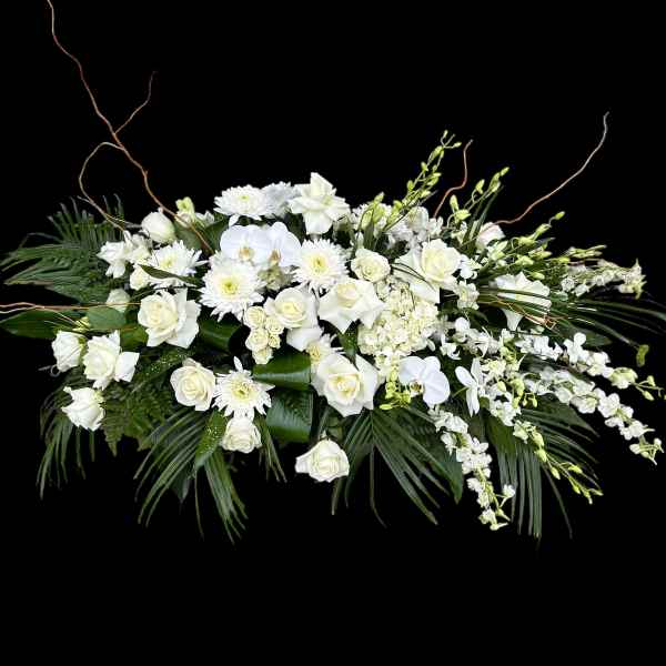 White floral arrangement with roses, orchids, and chrysanthemums