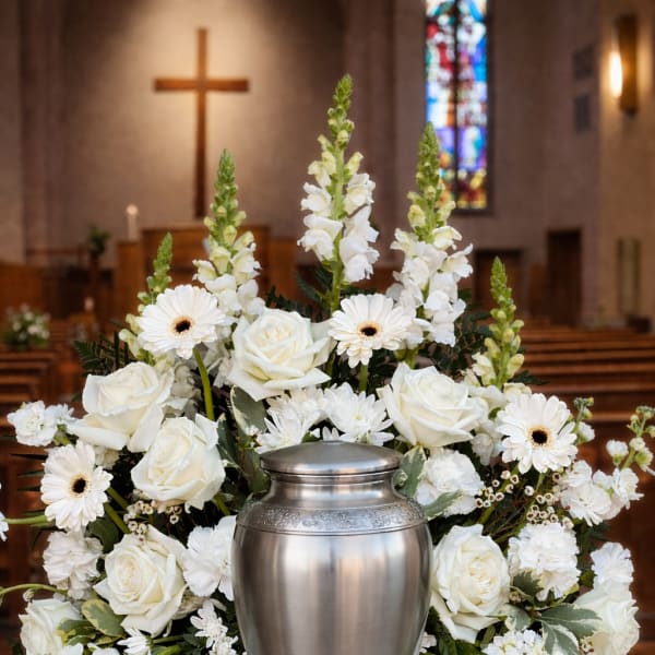 White floral funeral urn arrangement with roses and daisies