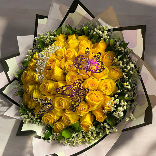 Bouquet of yellow roses with butterfly decorations and decorative wrap