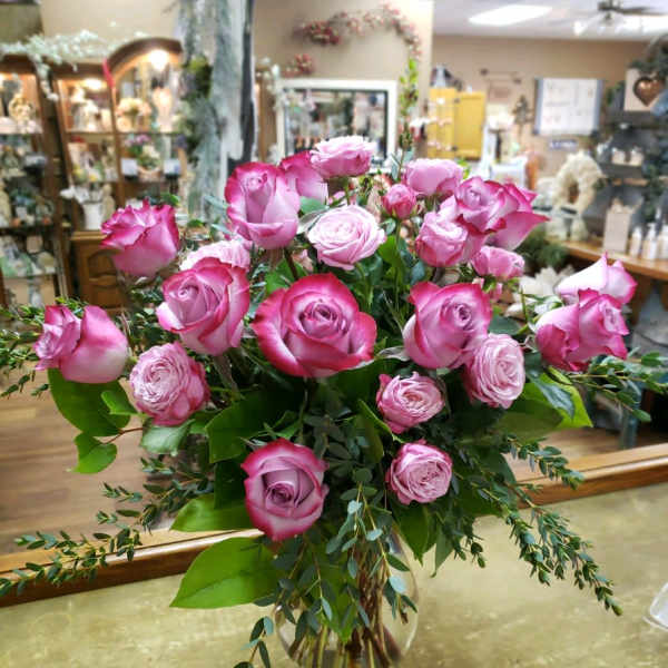 Pink roses arranged in a clear glass vase