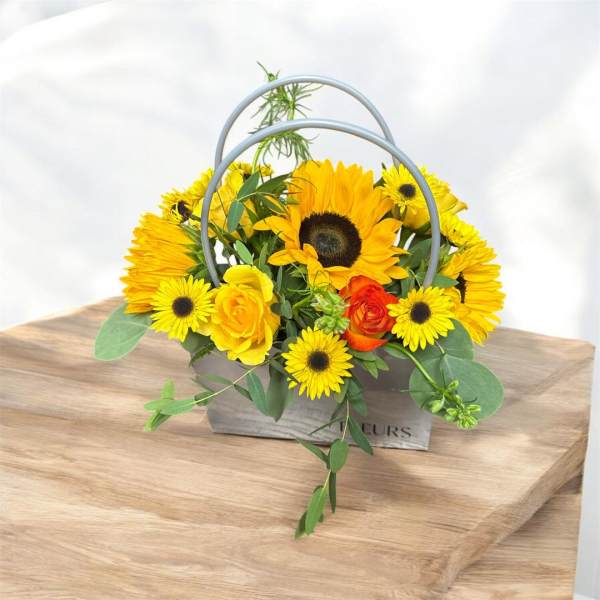 Yellow sunflower and rose arrangement in a gray handled box