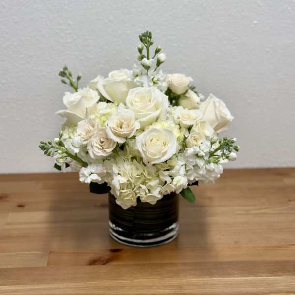 White rose bouquet in a dark glass vase