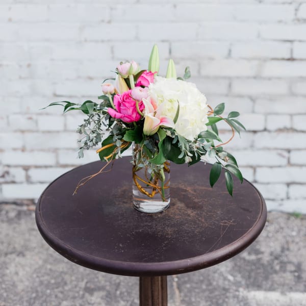 Pink and white floral arrangement in a clear glass vase