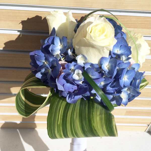 Blue hydrangea bouquet with white roses and striped leaves