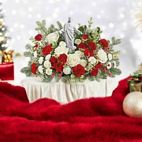 Red and white rose arrangement with a small statue centerpiece
