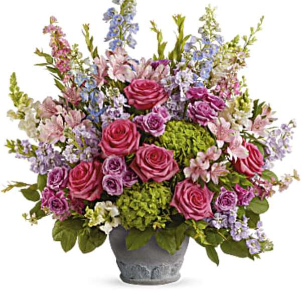 Mixed pink and lavender flowers in a gray pot
