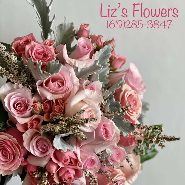 Pink rose bouquet with silver foliage and small filler flowers