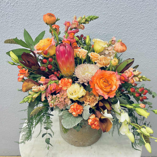 Colorful mixed flower arrangement in a round vase