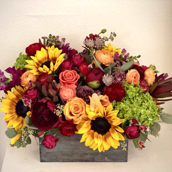 Mixed bouquet in a gray rectangular box with sunflowers and roses