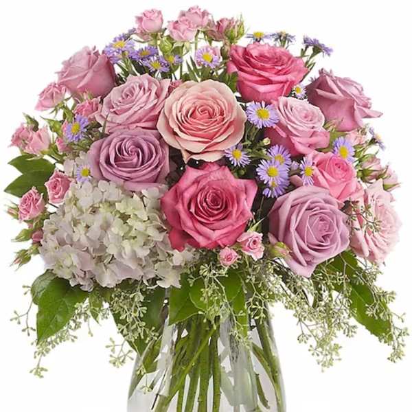 Pink and lavender rose bouquet in a clear glass vase