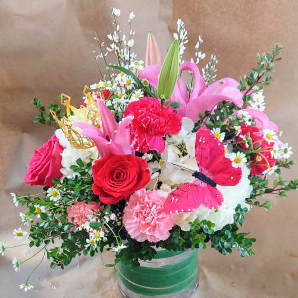 Pink and red mixed bouquet in a glass vase with a butterfly decoration