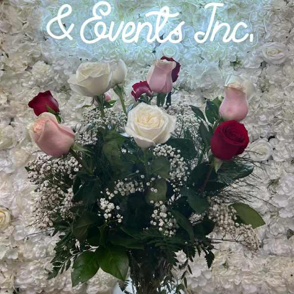 Bouquet of pink, white, and red roses in a glass vase