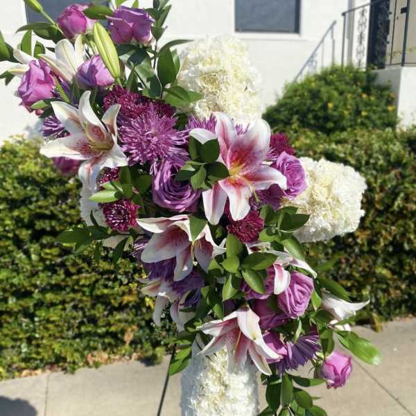 Large floral standing spray with pink and white lilies and purple blooms