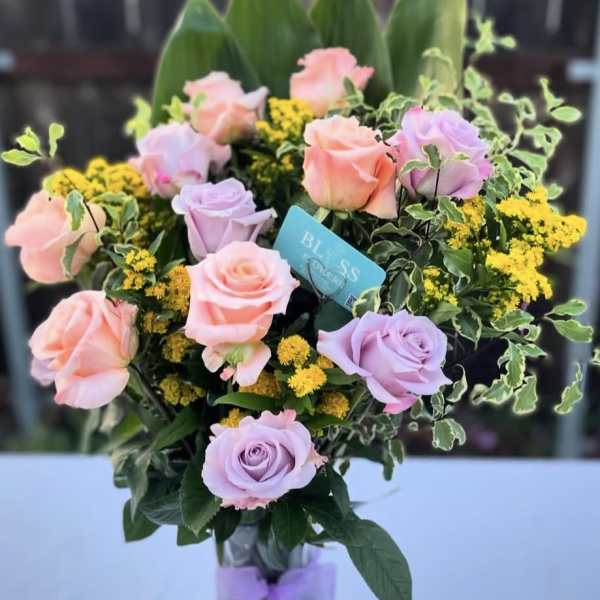 Bouquet of pink and lavender roses in a glass vase