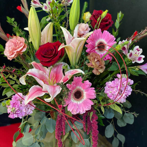 Mixed bouquet with pink lilies, red roses, and pink gerbera daisies