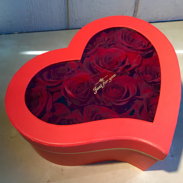 Heart-shaped red box filled with red roses