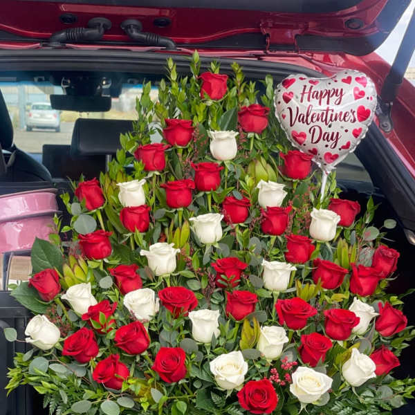 Large red and white rose arrangement in a wooden box with a Valentine balloon
