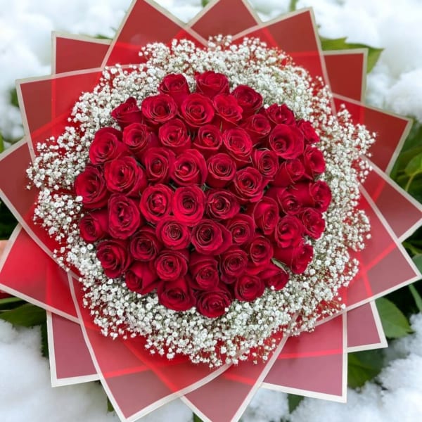 Round bouquet of red roses with white baby's breath