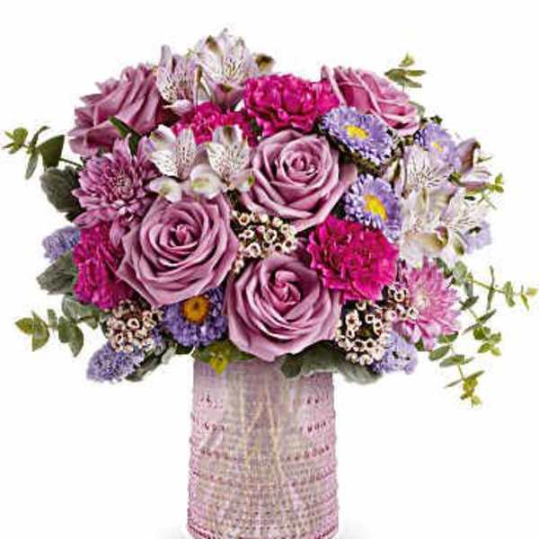 Lavender and pink bouquet in a textured pink vase