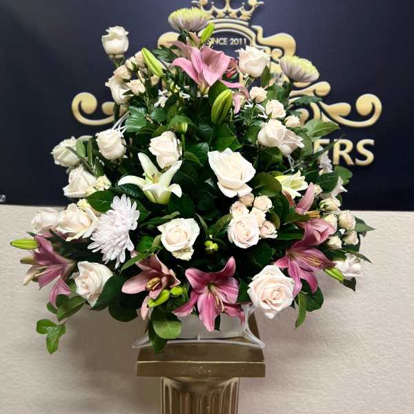 Pink lilies and white roses arranged in a vase
