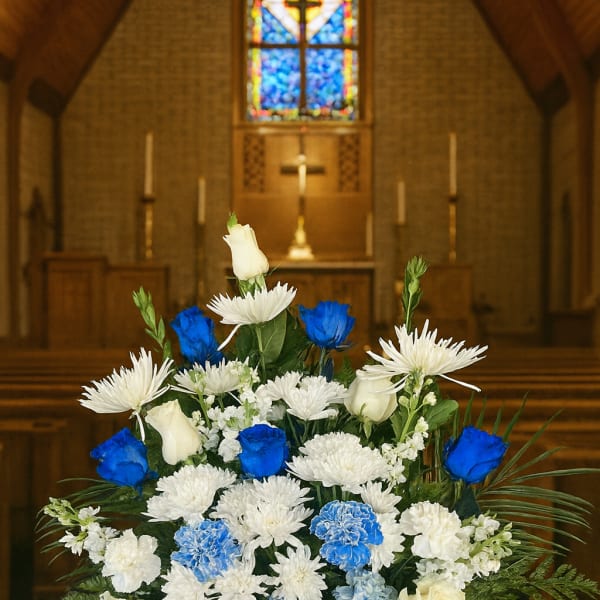 White and blue floral arrangement in a church setting