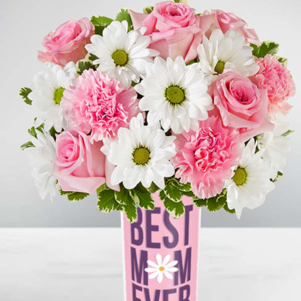 Pink roses, pink carnations, and white daisies in a tall vase labeled "Best Mom Ever".